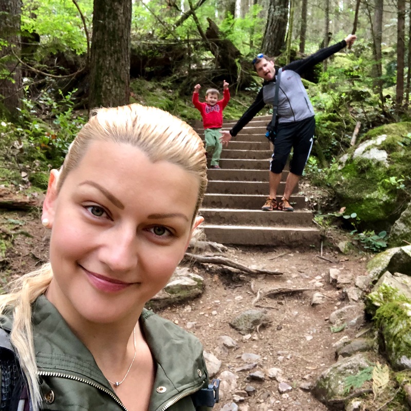 family having fun on a hiking trail in the forest