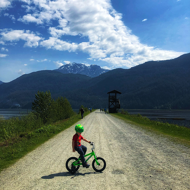 a child on his bike at Rannie Road in Pitt Lake Ecological Reserve, near Pitt Meadows, BC at Grant Narrows Regional Park