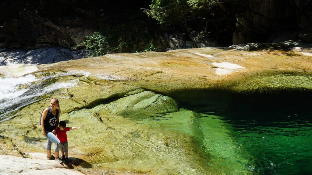 Alexandra and Cosmos enjoying deep greens of Gold Creek waters, as seen from atop the waterfall