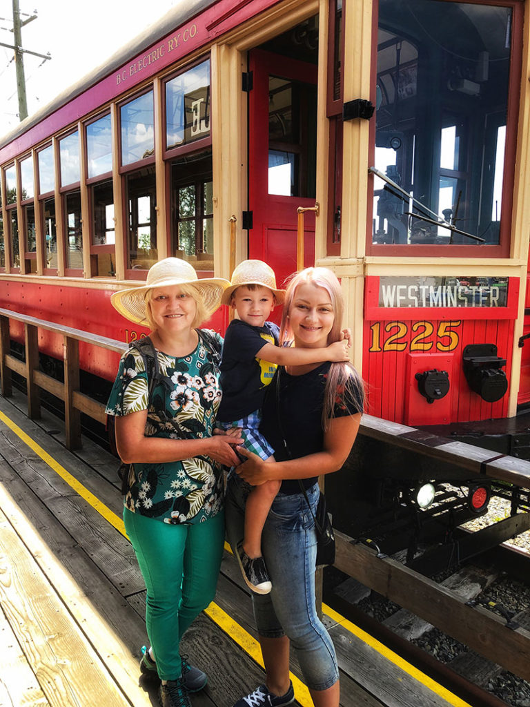 a family at Surrey Heritage Rail in front of an old train electric car - PerfectDayToPlay