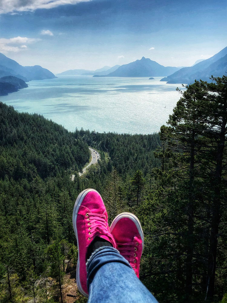 magenta shoes and the view of Howe Sound as seen from Jurassic Ridge hiking trail in Murrin Provincial Park BC Canada next to Squamish in the summer