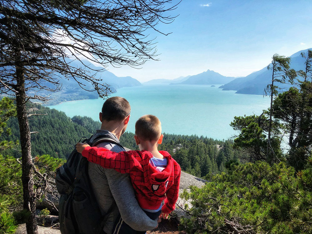 Father and son view the Jurassic Ridge hiking trail rope in Murrin Provincial Park near Squamish in BC Canada
