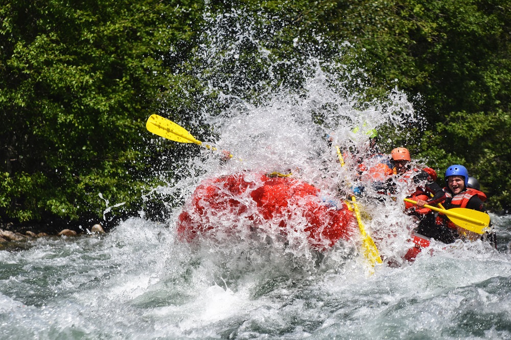 PerfectDayToPlay - raft with people in it splashing of the river