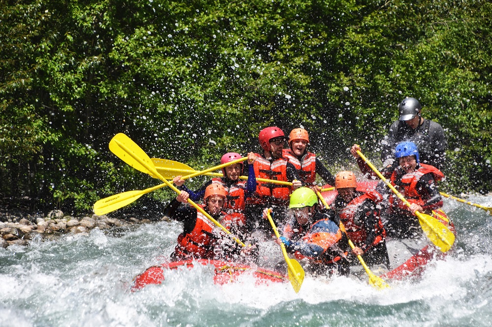 PerfectDayToPlay - people in a raft going through the rapids splashes of the river