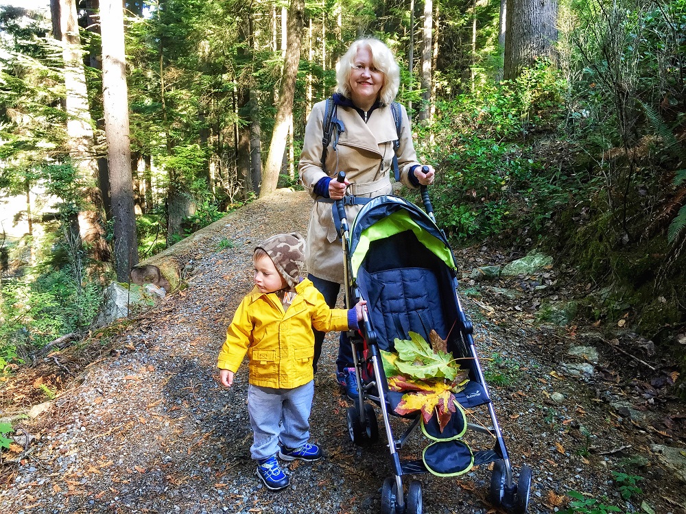 Fall hiking in Belcarra - child with grandma in a stroller collecting fall leaves