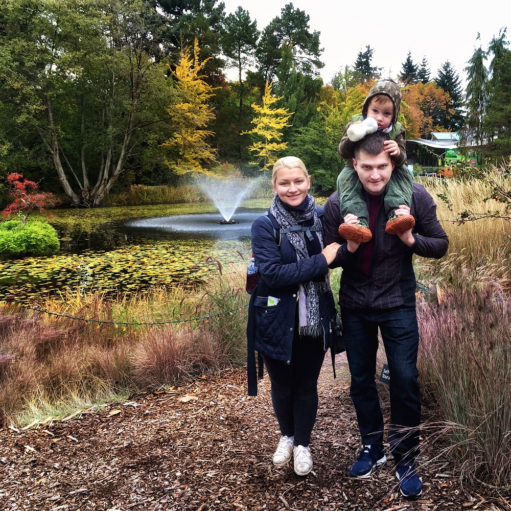 VanDussen Botanical Garden in the fall with family in front of a water fountain