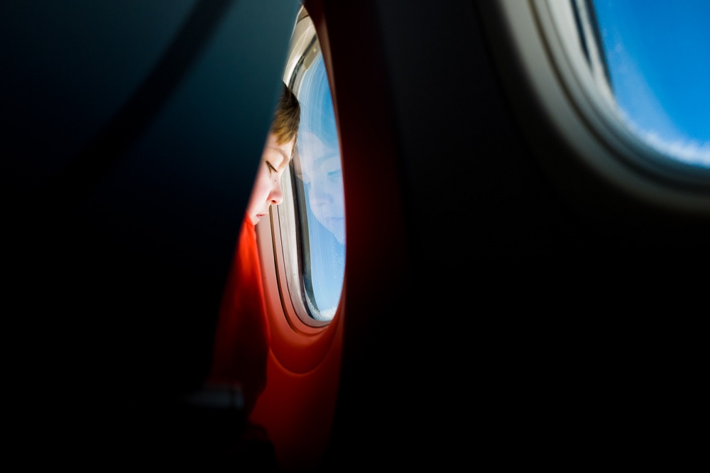 Toddler on a plane looking out of the window