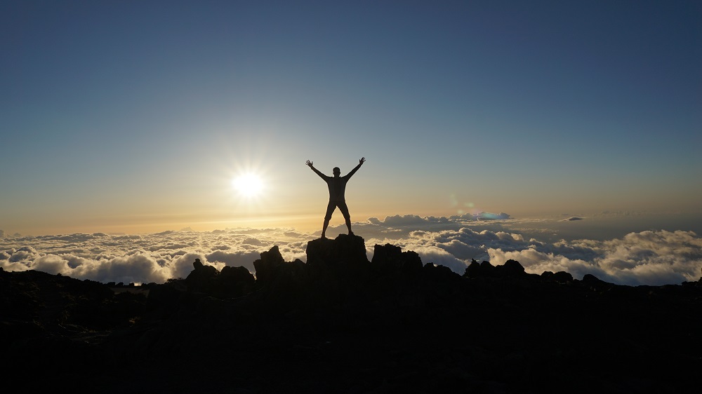 male silhouette above clouds at Haleakala Volcano in Maui Hawaii - inspire success achieve