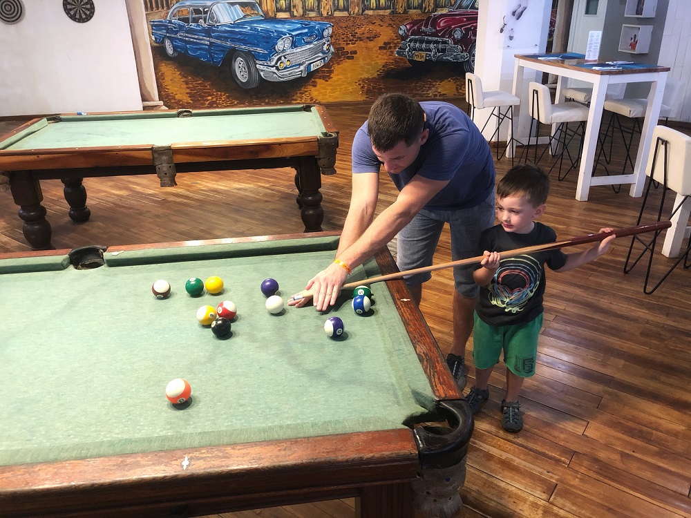 Father and son are playing pool