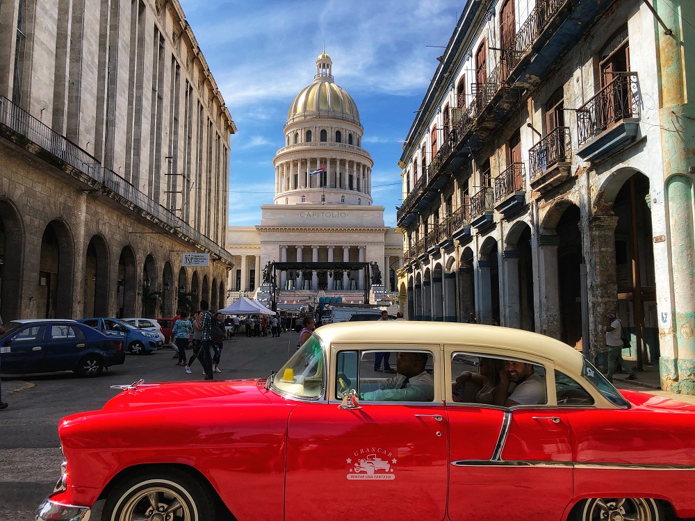 Capitol of Havana - streets of Habana and a red classic american car
