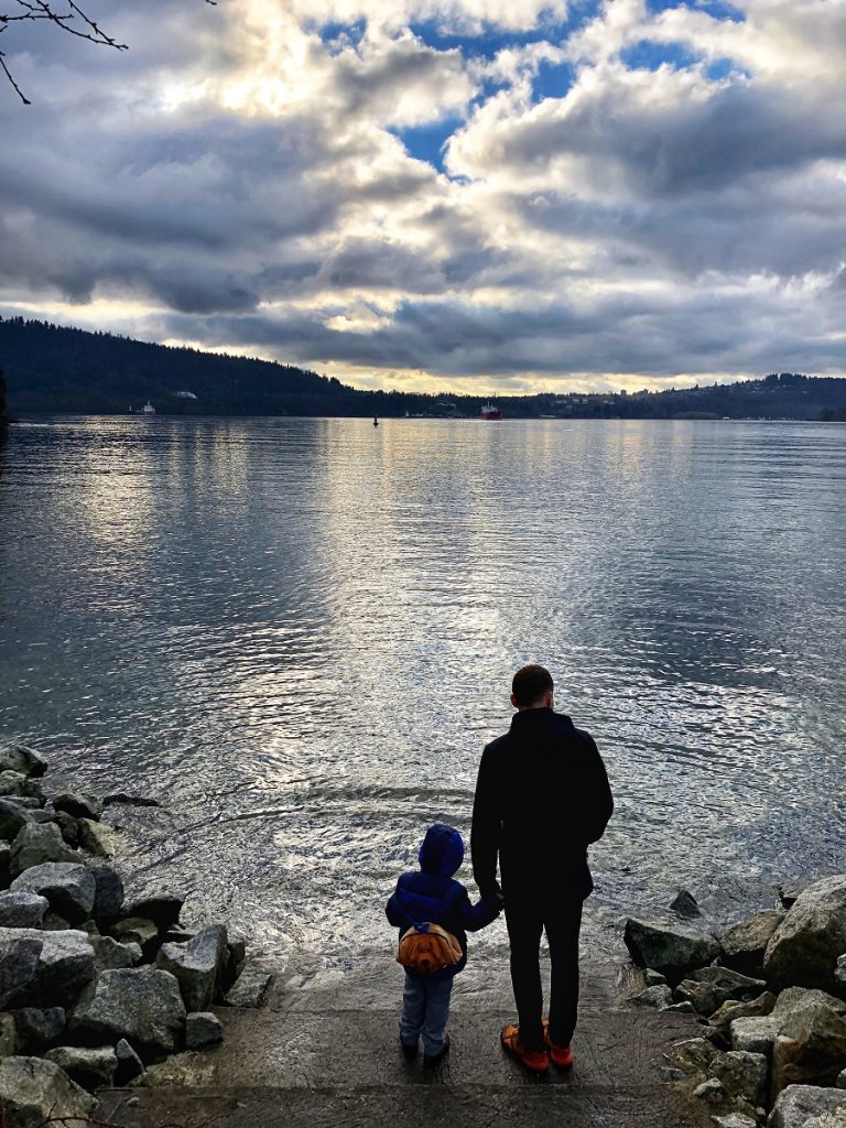 father and son watching sunset at Port Moody Shoreline trail - easy hiking near Coquitlam