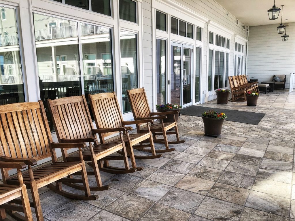 a row of rocking chairs at the outdoor deck