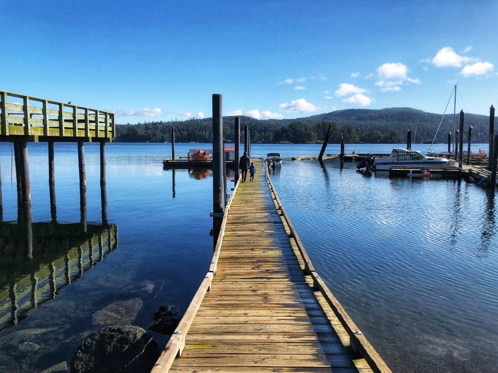 Prestige Oceanfront Resort Sooke, BC marina - pier with father and son walking
