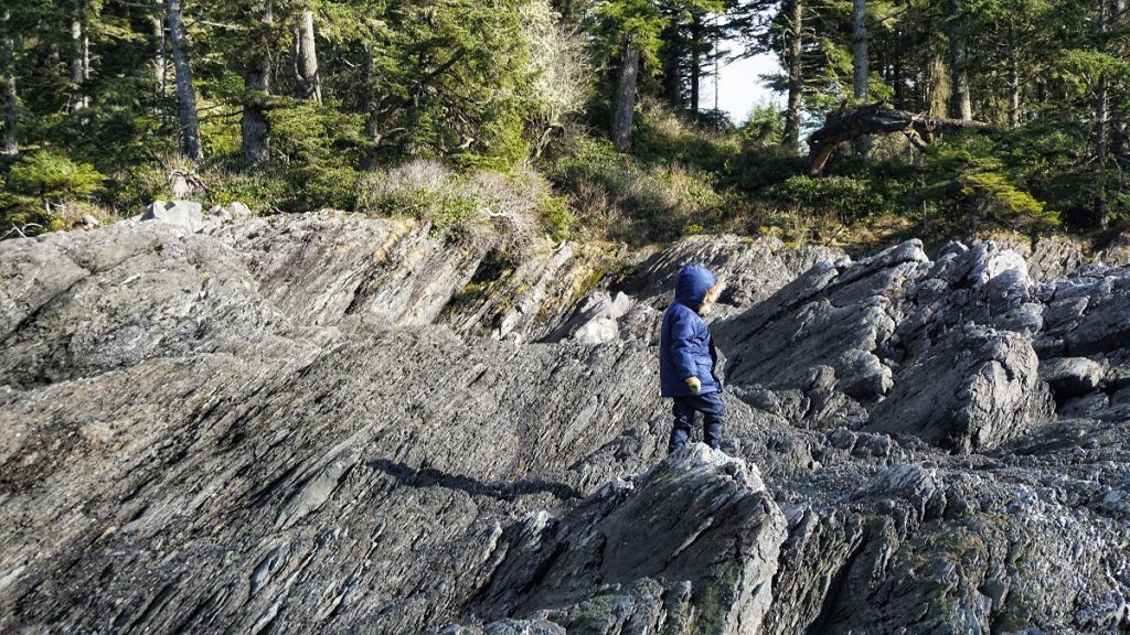 a child hiking rocky coastline shores of Vancouver Island