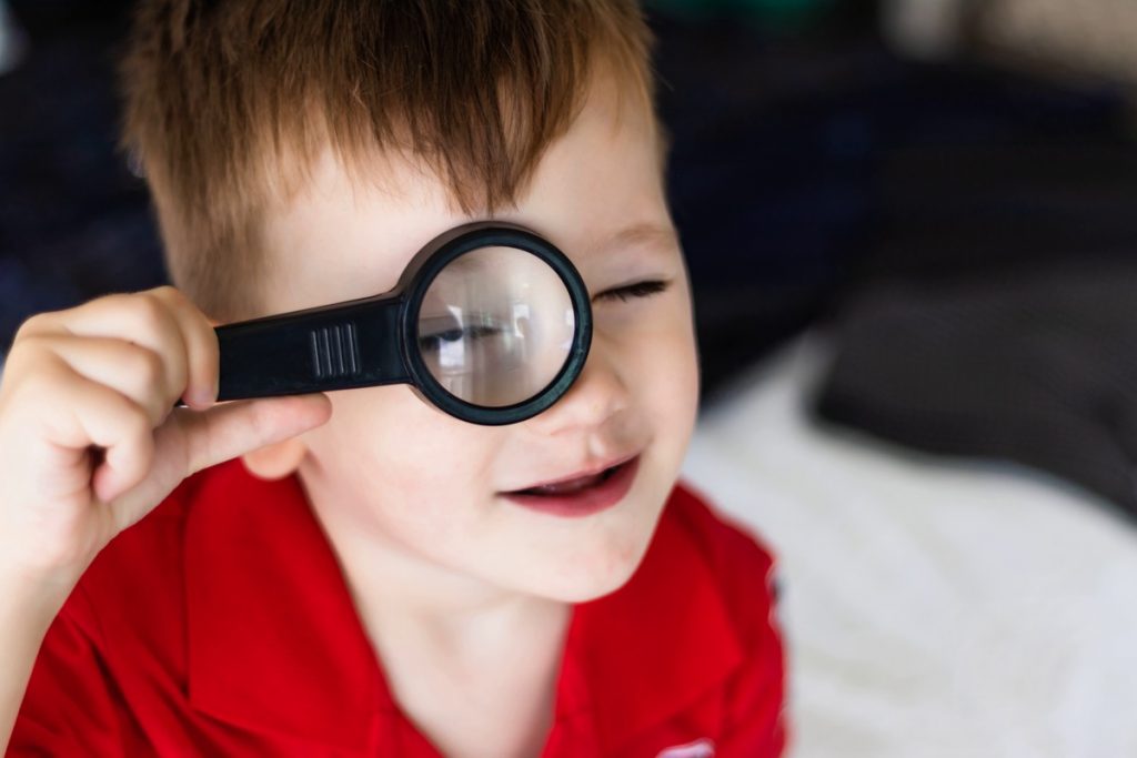 writing a hotel review - child with a magnifying glass