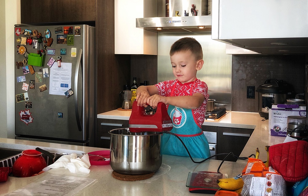 child using a mixer for baking at kitchen - creative cool kids indoor activities