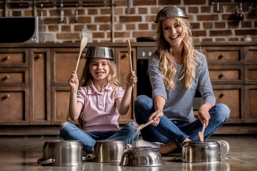 mother and daughter playing music using cooking pans - creative things to do with kids at home