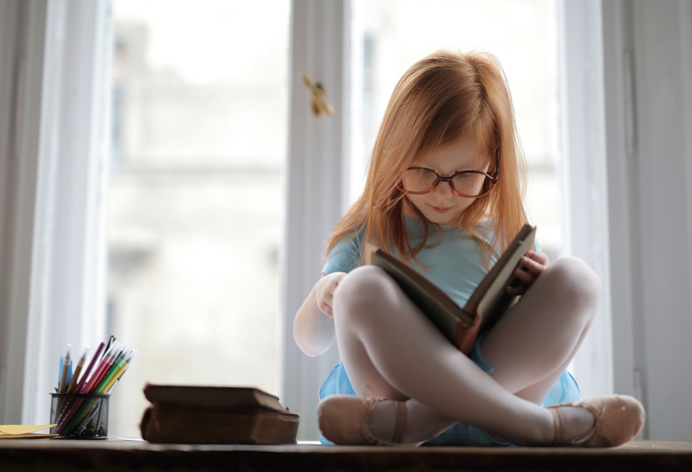 girl reading a book - indoor educational kids activities