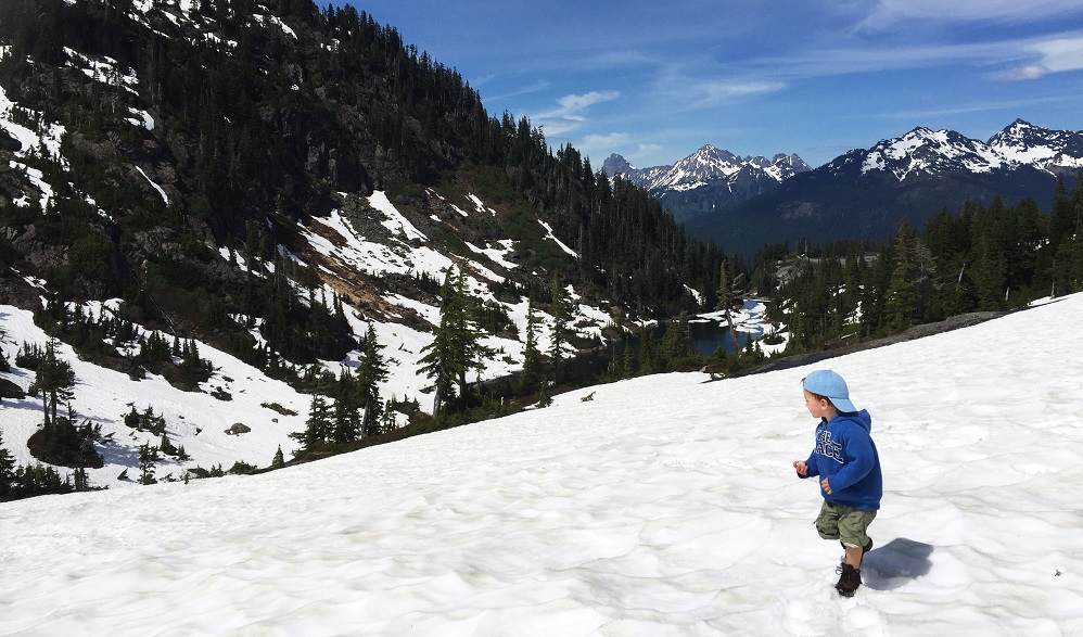 boy child hiking in snow in the mountains