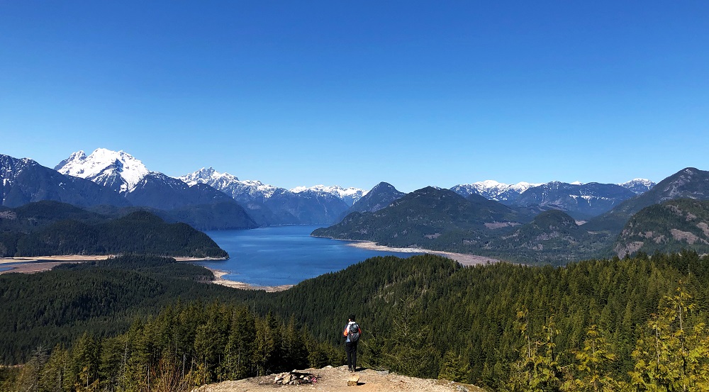 man looking over at Stave Lake from a mountain - Hunter Trail near Mission BC