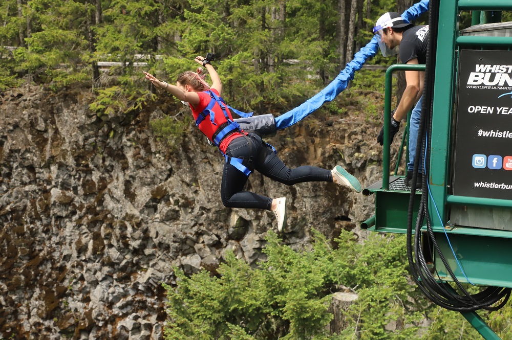 woman in red tshirt jumping from Whistler bungee bridge