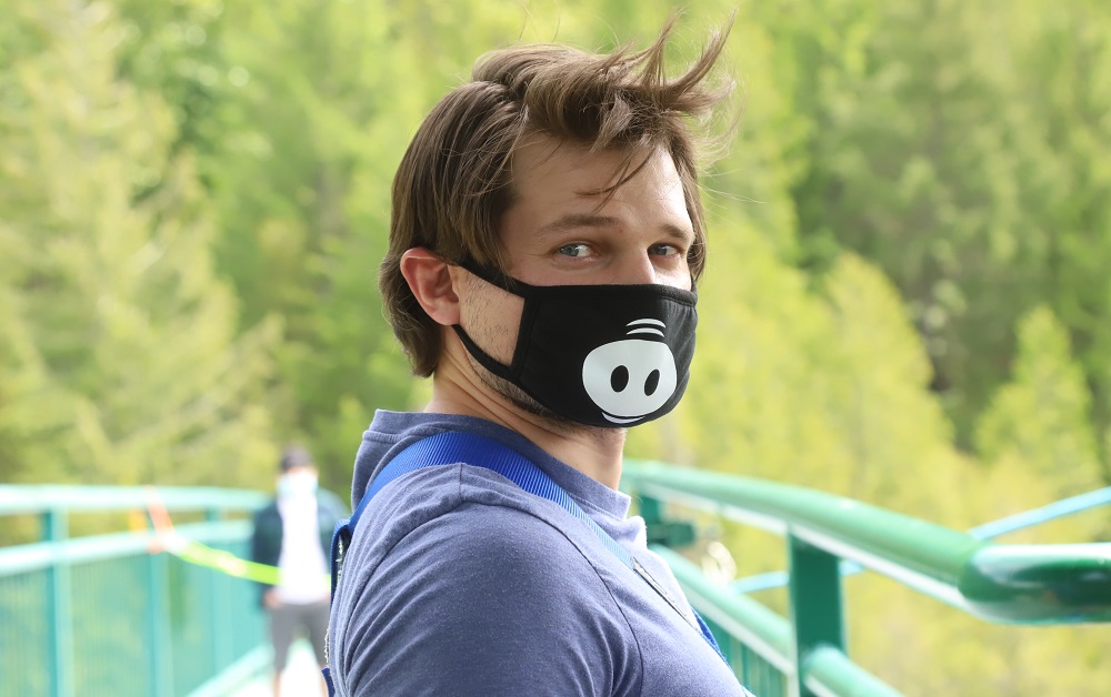 Man in a novelty face mask getting ready for bungee jumping