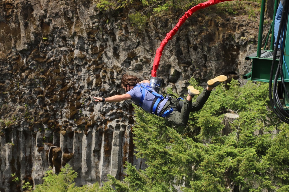 man in blue tshirt jumping from Whistler bungee bridge