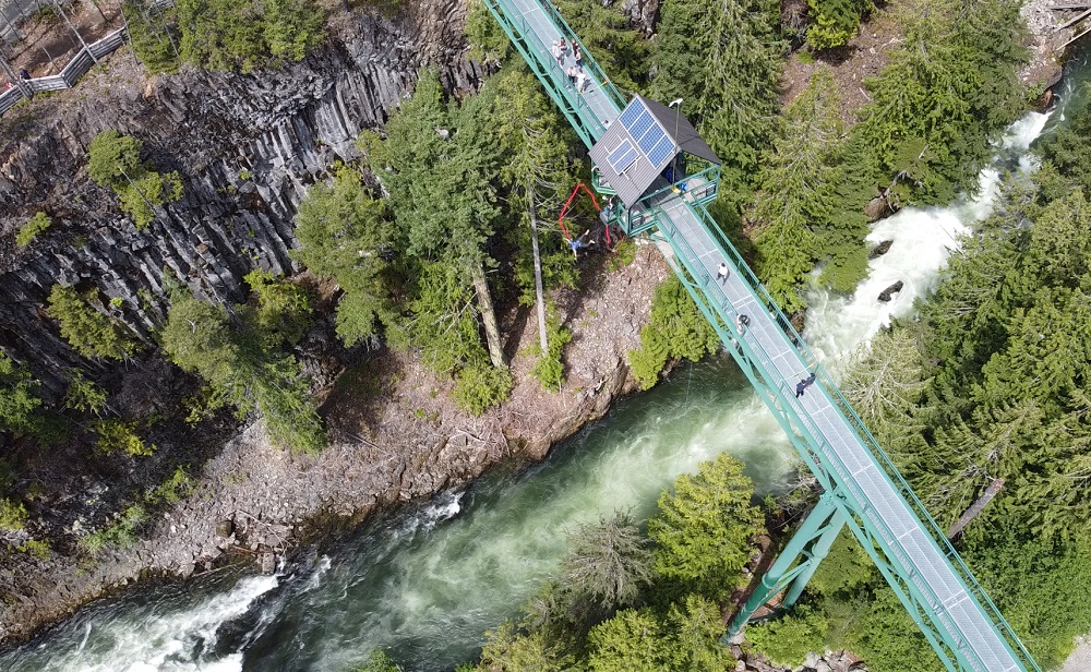 Whistler bungee bridge aerial view from a drone at 50m altitude and a bungee jumper