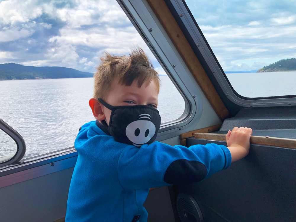 a child wearing mask on a water taxi ride