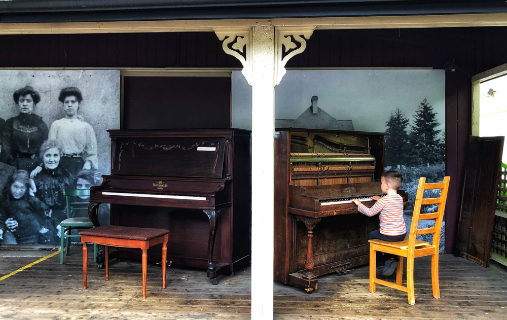 child playing piano outdoors in Fort Langley - things to do with kids
