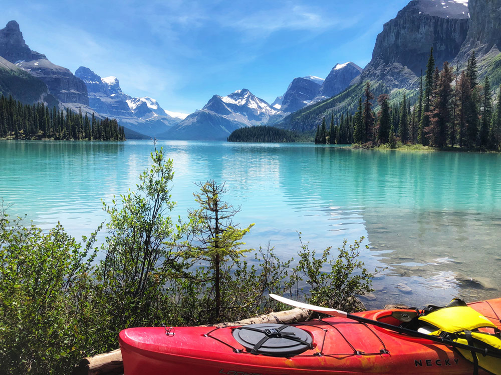 red kayak canoe and the beautiful view of the Spirit Island at Maligne Lake in Jasper Alberta