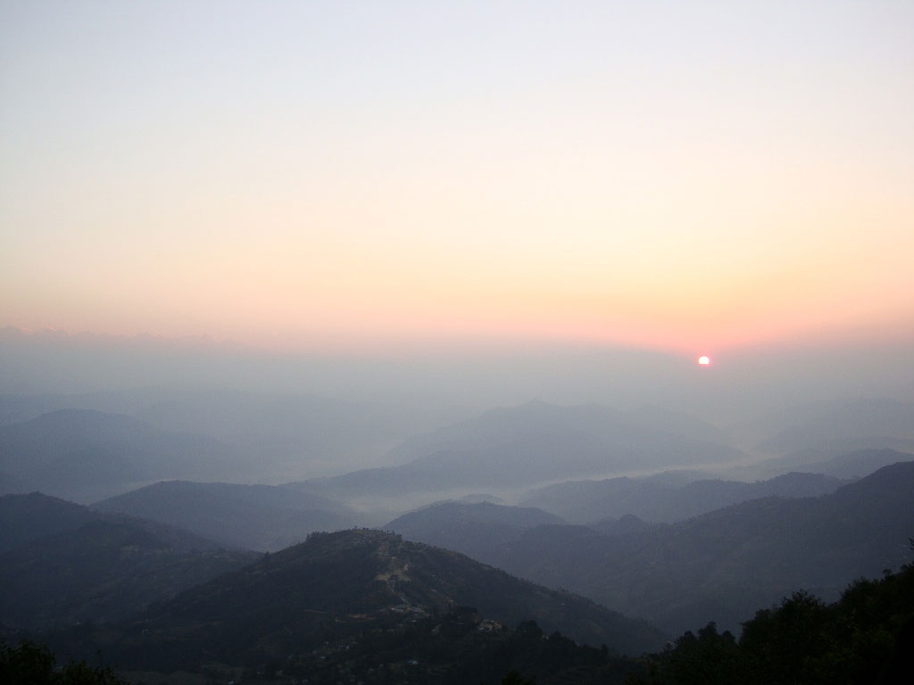 sunrise over the foggy Himalayan mountain peaks