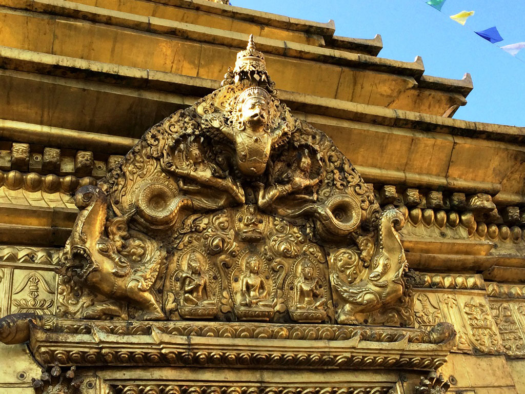 Golden ornament Hindu and buddhist religions symbols decorating  Swayabdhunath temple shrines, Kathmandu, Nepal