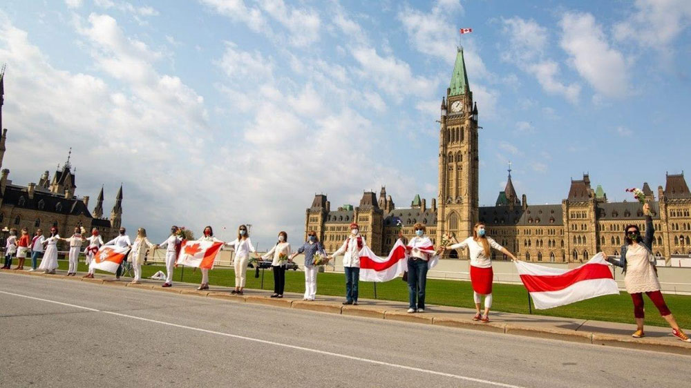 Belarusians holding hands at Parliament Hill in Ottawa, Ontario, Canada