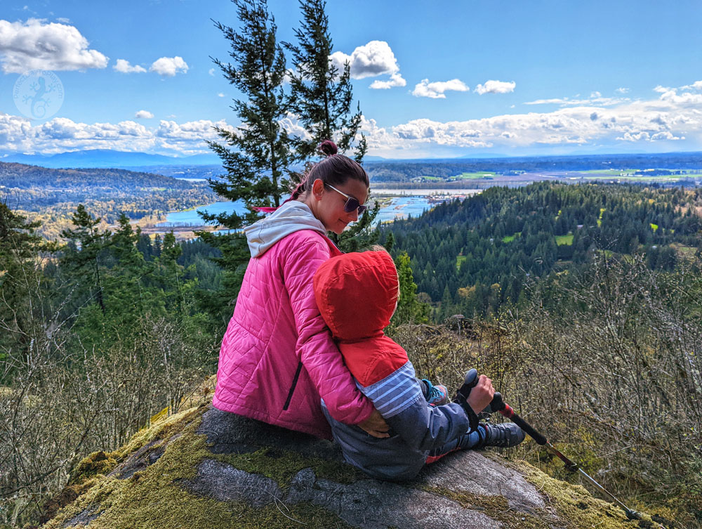 woman with a child hiking trail sitting watching the view