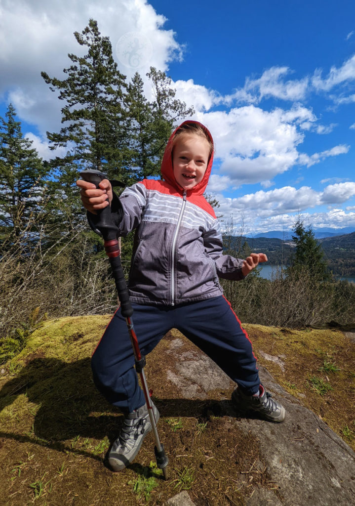 six year old child hiking with a pole