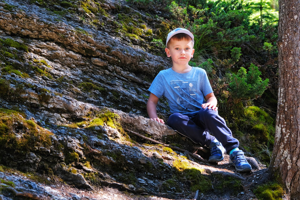 a child sitting on a rock